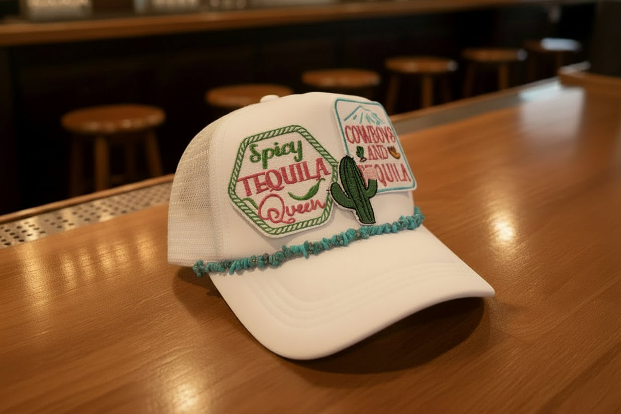 White cap with tequila-themed design on a wooden table