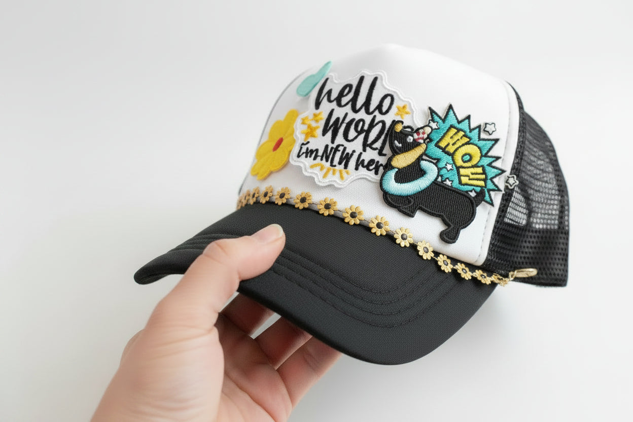 Black cap with colorful patches and text on a blurred background