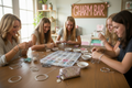 Create a tablescape of teenage girls making bracelets. The table has an array or ribbons, silver bracelets and a box with several compartments with charms in them. There is a sign in the background that says "charm bar" in Pink